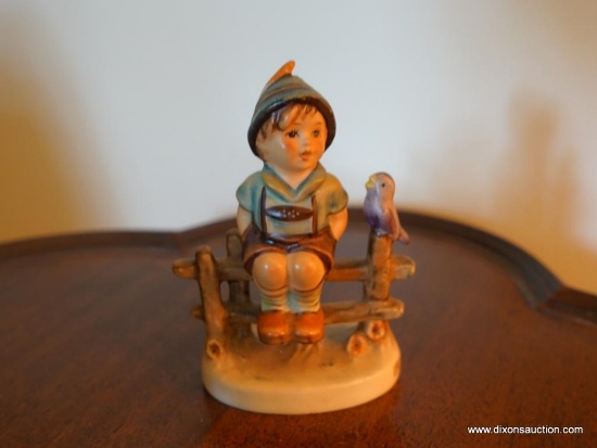 (LR) HUMMEL FIGURINE OF THE FENCE SITTER- MARKED WITH THE BEE-4"H