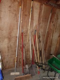 (SHED)ALL THE YARD TOOLS HANGING ON WALL AND BESIDE THE WALL, SHOVEL, AERATORS, RAKE, ETC.