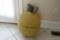 (TV) PINEAPPLE BASKET; LIFT TOP PINEAPPLE BASKET. YELLOW AND GREEN IN COLOR: 15 IN X 25 IN. HAS SOME