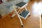 (REC) FOLDING STEP STOOL; 2 STEP MODEL, WHITE METAL FRAME WITH BLACK GRIPPING SURFACE STEPS.