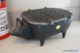 (LAU) CAST IRON GRILL; BLACK IN COLOR, SHAPED LIKE A PIG, HAS REMOVABLE GRATES INSIDE AND ON TOP,