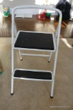 (MLR) WHITE/BLACK STEP STOOL; METAL WITH GRIPPING SURFACE ON STEPS, FOLDS FOR EASY STORAGE. STANDS