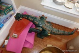 (REC) LARGE TOY DINOSAUR; GREEN AND ORANGE IN COLOR, MOVABLE AND POSEABLE JOINTS. MEASURES ABOUT 3