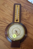 (REC) VTG BAROMETER; MADE BY TAYLOR, WITH WOODEN BODY AND ROUND FACE. MEASURES ABOUT 12 IN LONG.
