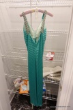 (CLO2) LADIES FORMAL EVENING GOWN; LIGHT GREEN SATINY SLEEVELESS GOWN WITH A FOLDED OR FAN DETAIL ON