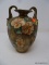 NIPPON HAND PAINTED VASE; TAN, PINK AND GREEN IN COLOR WITH FLORAL PATTERN. STANDS 9.5 IN TALL