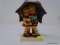 GOEBEL HUMMEL FIGURINE; DEPICTS A LITTLE BOY AND GIRL UNDER AN UMBRELLA. FIRST EDITION (1997).