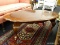 MAHOGANY COFFEE TABLE; HAS QUEEN ANNE FEET AND BANDED TURTLE SHELL SHAPED TOP. MEASURES 46 IN X 25