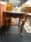 MAHOGANY END TABLE (1 OF A PAIR); HAS QUEEN ANNE FEET AND BANDED TURTLE SHELL SHAPED TOP. MEASURES