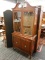 MAHOGANY STEPBACK CABINET; HAS 2 UPPER GLASS DOORS WITH LATTICE PANELS AND 2 LOWER DOORS WITH 1