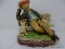 (DIS) HOBO FIGURINE; VINTAGE HAND PAINTED FIGURINE OF A HOBO SITTING ON A PARK BENCH WITH A DOG.