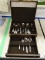 (CASE) FLATWARE SETS IN WOODEN STORAGE BOX; DARK STAINED WOODEN BOX LINED IN BROWN FELT, CONTAINS