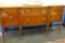 BERKEY AND GAY SIDEBOARD; FLAME MAHOGANY WITH A BOW FRONT DESIGN. SINGLE CENTER DRAWER FLANKED ON