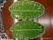 OLFAIRE GREEN LEAF SHAPED PLATTERS; TOTAL OF 2 PIECES. EACH PLATTER IS 15 IN LONG.