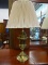 PAIR OF TABLE LAMPS WITH TURNED BRASS URN STYLE BASES AND FOLDED PLEATED BEIGE LAMP SHADES; EACH