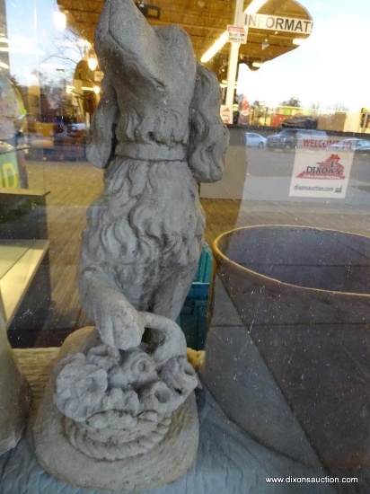 CONCRETE DOG STATUE; A SETTER OR SPANIEL TYPE DOG IS SEATED WITH A FRONT PAW PERCHED ON A SMALL