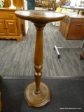 TALL WOODEN PLANT/CANDLE STAND; ROUND TOP SURFACE WITH TURNED POST AND ROUND BASE. MEASURES ABOUT