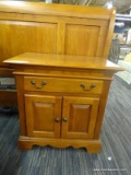 SUMTER CABINET CO NIGHT STAND; SINGLE DRAWER OVER DOUBLE DOOR CABINET, CARVED BRACKET FRONT BASE.