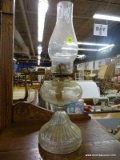 VINTAGE CLEAR GLASS OIL LAMP; COMES WITH BASE, CHIMNEY, AND WICK. STANDS ABOUT 18 IN TALL.