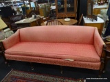 VINTAGE LONG LIGHT RED SOFA; MAHOGANY FRAME WITH FLUTED FRONT POSTS AND LEGS. SINGLE CUSHION AND