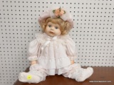 LARGE BABY DOLL; IN PINK OUTFIT WITH PINK AND FLORAL BONNET. HAS PORCELAIN FACE, HANDS AND BLONDE