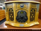 VINTAGE STYLE RADIO/TURNTABLE BY THOMAS PACCONI CLASSICS; BOWED FRONT WITH CARVED DETAILS AND HINGED
