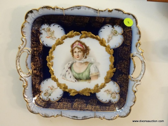 (ENTRANCE HALLWAY) 10" 2 HANDLED FRENCH FLO BLUE PORTRAIT PLATE WITH CUPIDS SURROUNDING THE