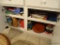 (KIT) CONTENTS OF LOWER CABINET OF ISLAND- PLACEMATS, KITCHEN TOWELS, CHRISTMAS CANDLES ( NEW IN
