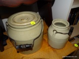 (DEN) 2 VINTAGE STONEWARE CROCKS WITH HANDLES. 1 HAS A LID: 8 IN TALL. 1 WITHOUT A LID: 6 IN TALL