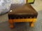(BED1) STEP STOOL WITH LEATHER UPHOLSTERED TOP AND BRASS RIVETS AROUND THE EDGE AND WITH OAK LEGS: