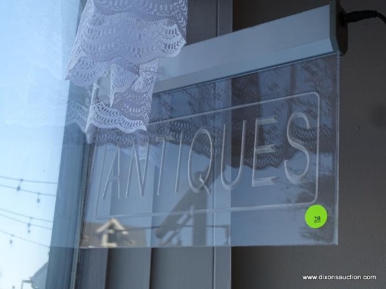 "ANTIQUES" WINDOW SIGNAGE; HANGING LUCITE SIGN WHICH IS ETCHED WITH WORD "ANTIQUES" ACROSS. COMES