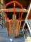 VINTAGE WESTERN CLIPPER SNOW SLED; MADE OF WOOD WITH PAINTED TRIM AND A RED METAL FRAME AND RAILS,