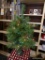 SMALL CHRISTMAS TREE; WITH MULTICOLORED LIGHTS, MEASURES 3 FT TALL, COMES WITH BASE.