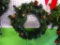 WREATH; GREEN PRE LIT WREATH WITH PINE CONE ACCENTS. MEASURES 21 INDIA AND IS READY FOR YOUR FRONT