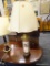 VINTAGE CANISTER TABLE LAMP; CREAM COLORED SCALLOPED SHADE SITTING ATOP A BRASS BASE THAT LOOKS AS