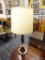 TABLE LAMP; THIS TABLE LAMP HAS A CREAM COLORED BELL SHAPED SHADE WITH GOLD ROPE DETAILING WITH A