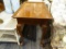 RECTANGULAR SIDE TABLE; WOODEN SIDE TABLE WITH A BEVELED RECTANGULAR TOP, CARVED SIDE CURTAINS, A