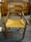 RUSH BOTTOM ARM CHAIR; THIS CHAIR HAS A LADDER BACK, TWO ROLLED SIDE ARMS, AND A RUSH BOTTOM SEAT.