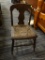 VINTAGE CANE SEAT CHILD'S CHAIR; WOODEN CHAIR WITH FIDDLE BACK SUPPORTED BY POSTS THAT LEAD DOWN TO