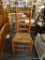 RUSH BOTTOM CHAIR; THIS CHAIR HAS A LADDER BACK SUPPORTED BY TWO POSTS WITH TAPERED TOPS, A RUSH