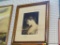 FRAMED PORTRAIT; THIS IS A FRAMED PAINTING OF A WOMAN LOOKING DOWN. THE BOTTOM HAS PRINT THAT READS