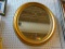 FRAMED MIRROR; OVAL FRAMED MIRROR IN GOLD TONED FRAME. MEASURES 25 IN X 19 IN
