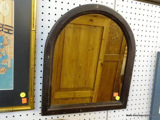 ANTIQUE WALL MIRROR; ARCHED TOP MIRROR FRAMED IN A DARK BROWN FRAME. SPECKLES IN MIRROR AND WEAR TO