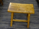 WOODEN SADDLE STOOL; SADDLE STOOL WITH SLIGHTLY RAISED SIDES. THIS STOOL IS A VERY SIMPLE BLOCK