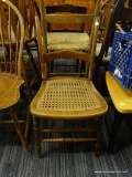 CANE SEAT CHAIR; THIS CHAIR IS MISSING THE TOP RAIL, THE CENTER RAIL IS CURVED AND IT HAS AN INTACT