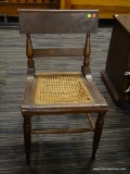 VINTAGE CANE SEAT CHAIR; WOODEN CHAIR WITH FLAT TOP AND CENTER RAILS SUPPORTED BY TURNED POSTS THAT