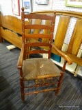 VINTAGE CANE SEAT CHAIR; WOODEN CHAIR WITH FIDDLE BACK SUPPORTED BY POSTS THAT LEAD DOWN TO A CANE