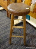 BAR STOOL; BROWN CUSHION SEAT BAR STOOL WITH 4 BRACED TAPERED LEGS. MEASURES 30 IN TALL BY 12 IN