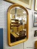 FRAMED MIRROR; MEDIUM SIZED MIRROR WITH ARCHED TOP. THIS MIRROR IS FRAMED IN A WOOD FRAME THAT HAS