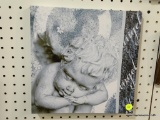 PRINTED ANGEL CANVAS; THIS IS A STRETCHED CANVAS WITH A CHERUB ANGEL ON IT. MEASURES 11 IN X 11 IN.